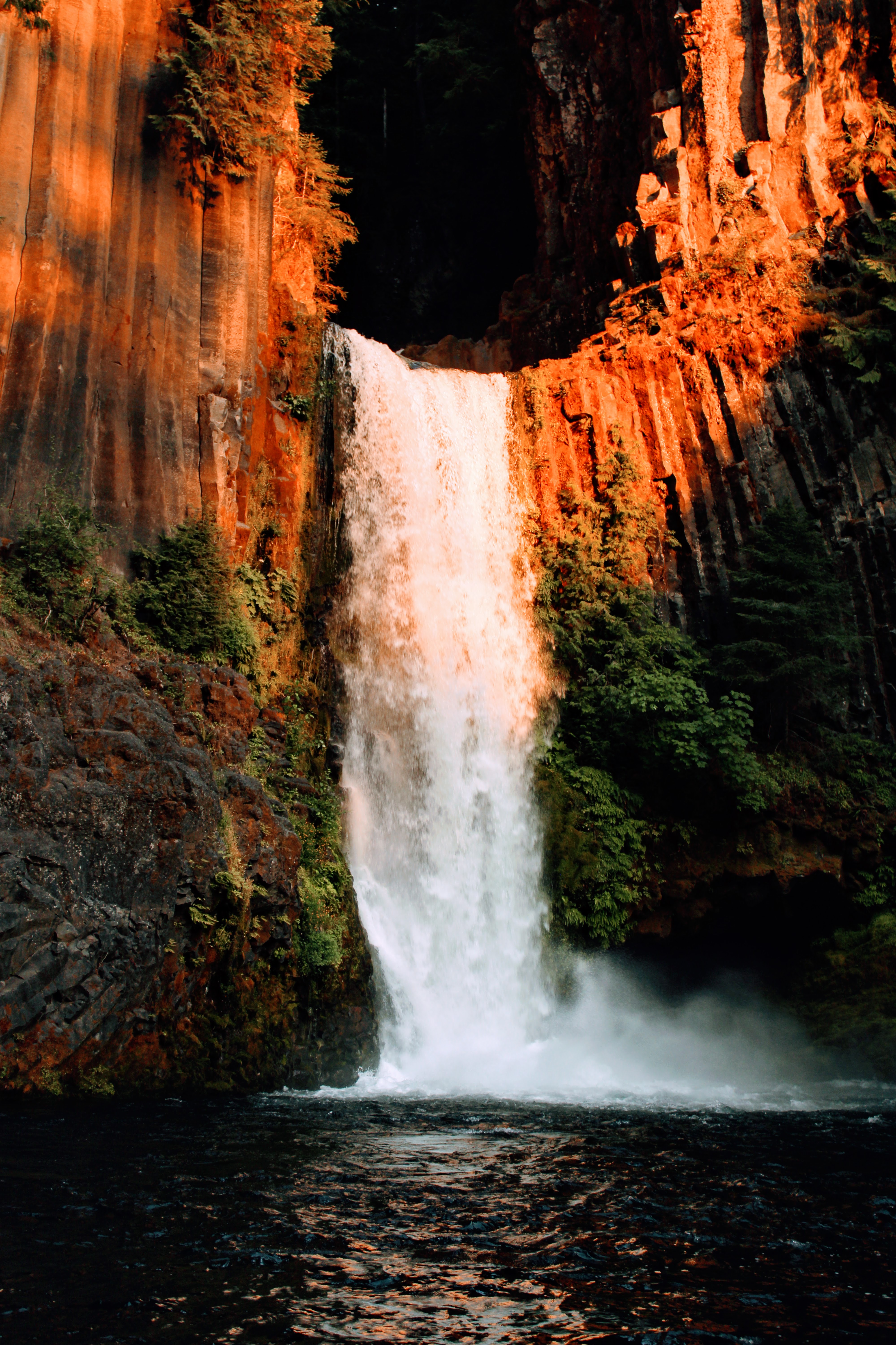 Waterfall cascading through a rocky forest landscape