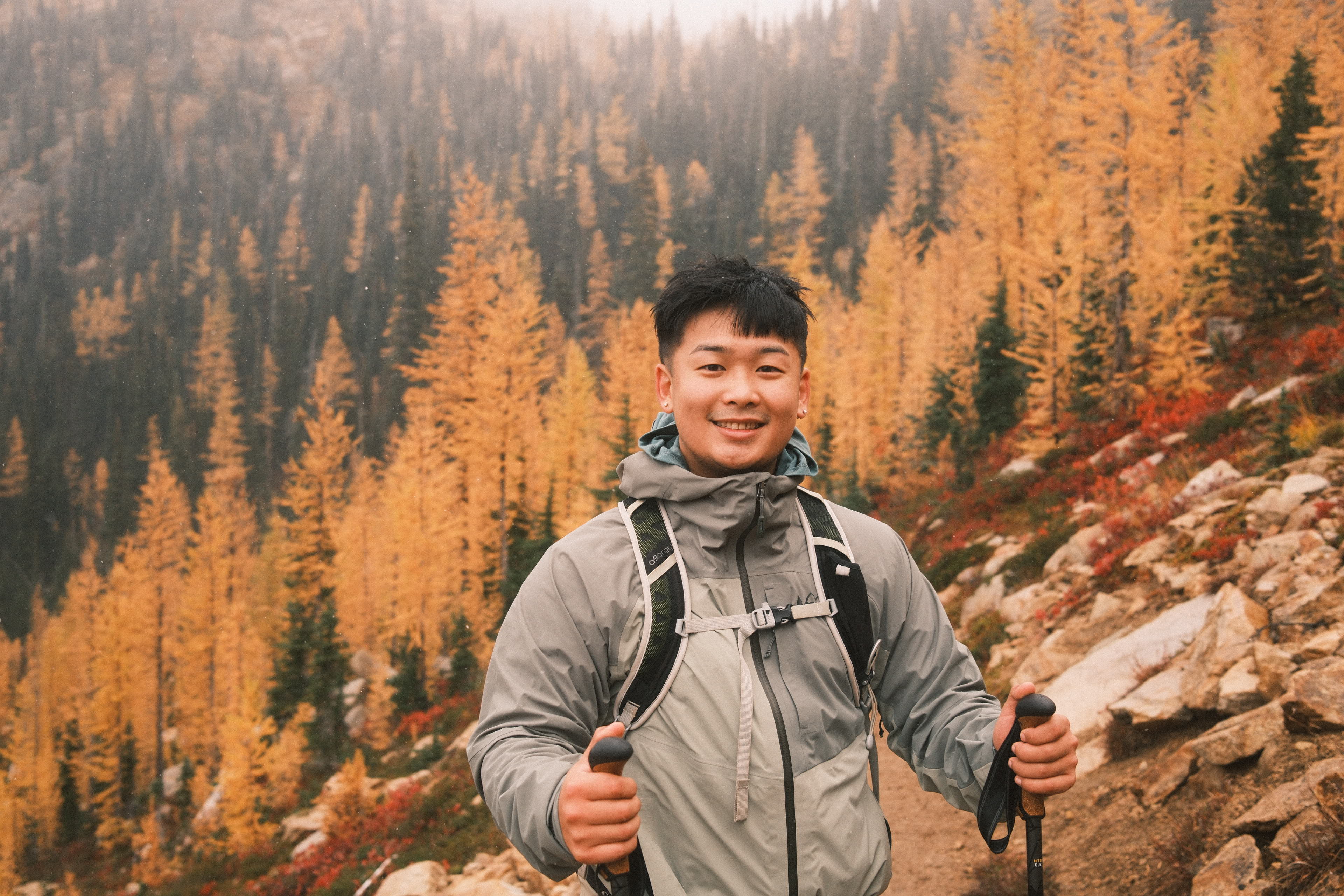 Patrick Tang in the mountains among golden autumn trees